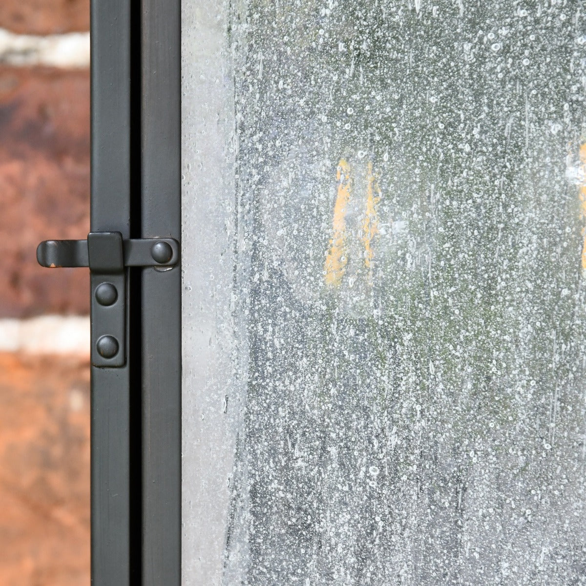 Close up of door clasp and frosted glass 