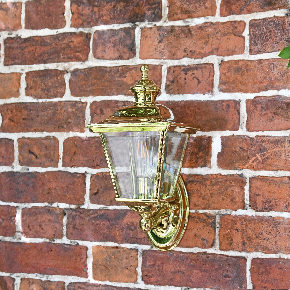 Polished Brass Four Sided Wall Lantern On Brick Wall