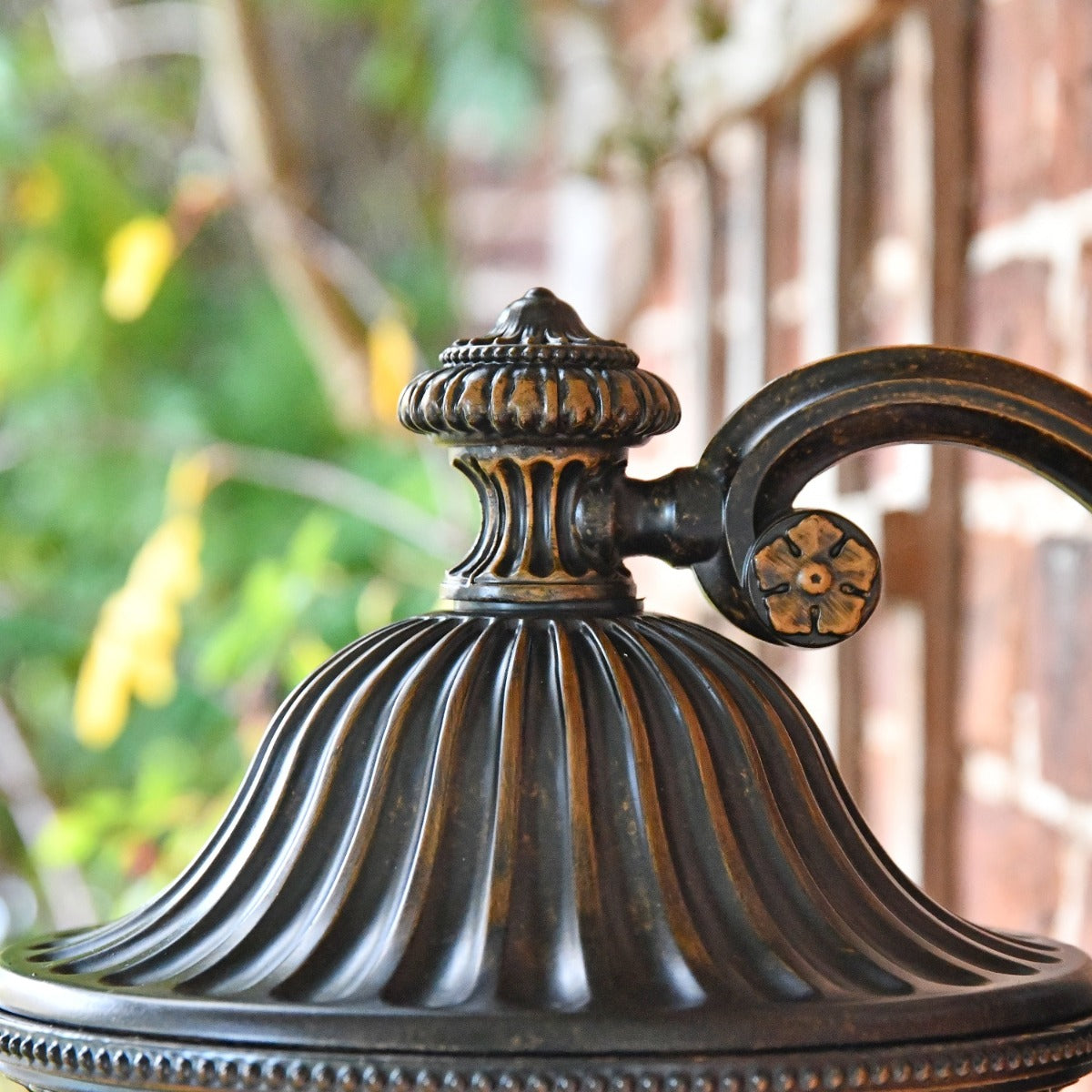 Close up of top decorative finial and arm bracket 