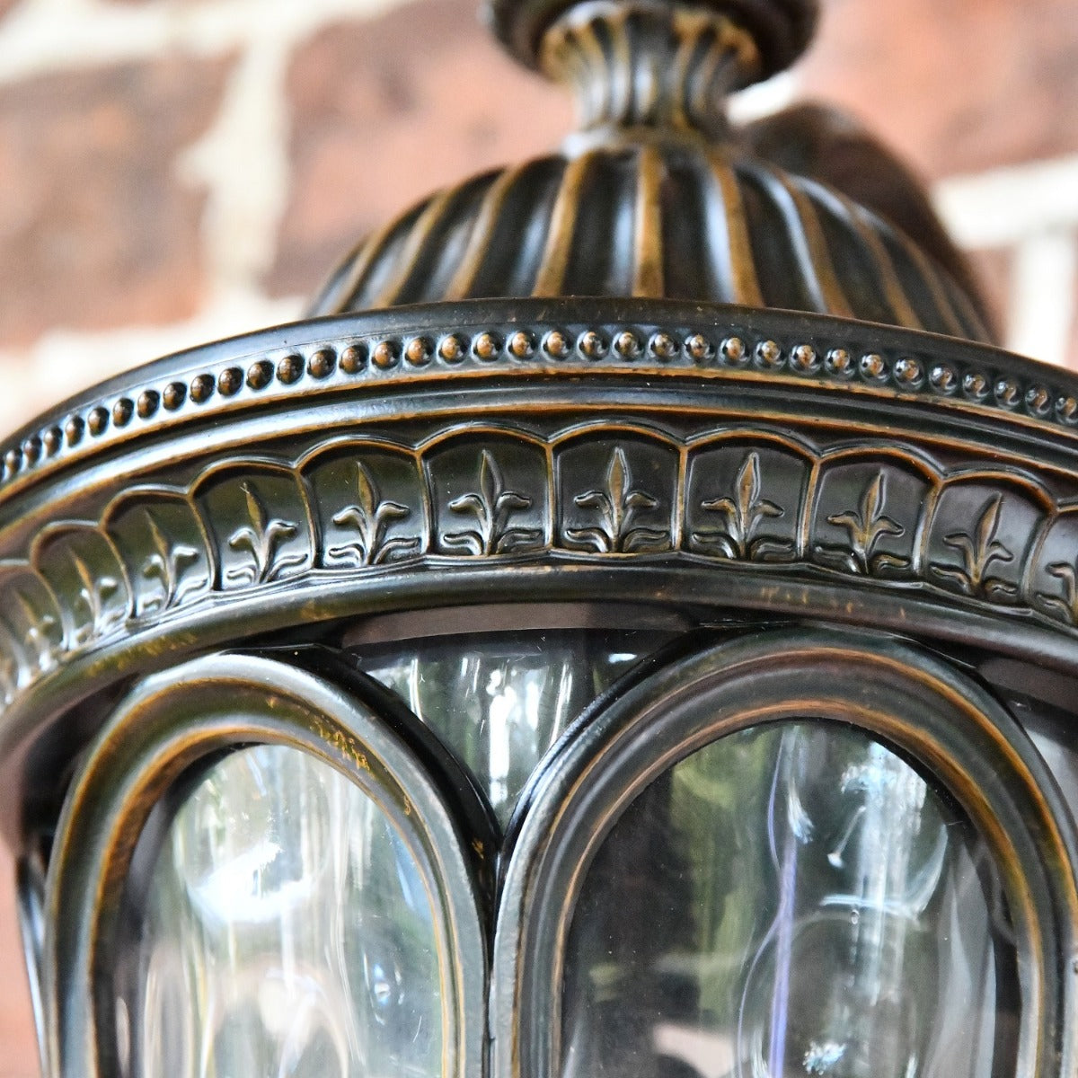 Close up of decorative fleur de lys detailing on lantern 