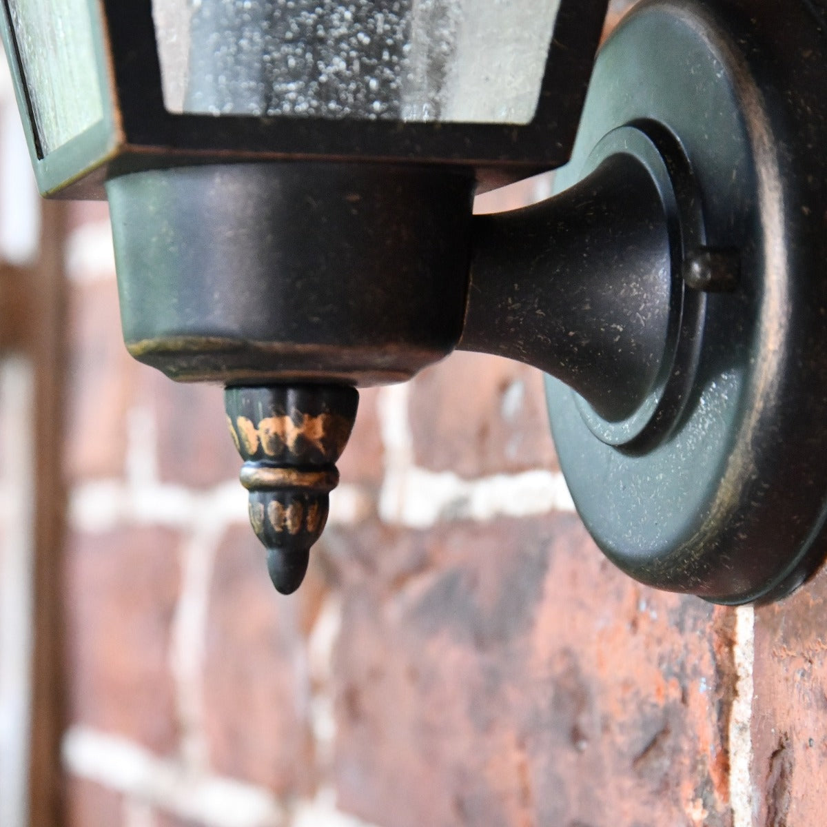 Close up of circular mounting bracket and bottom finial 