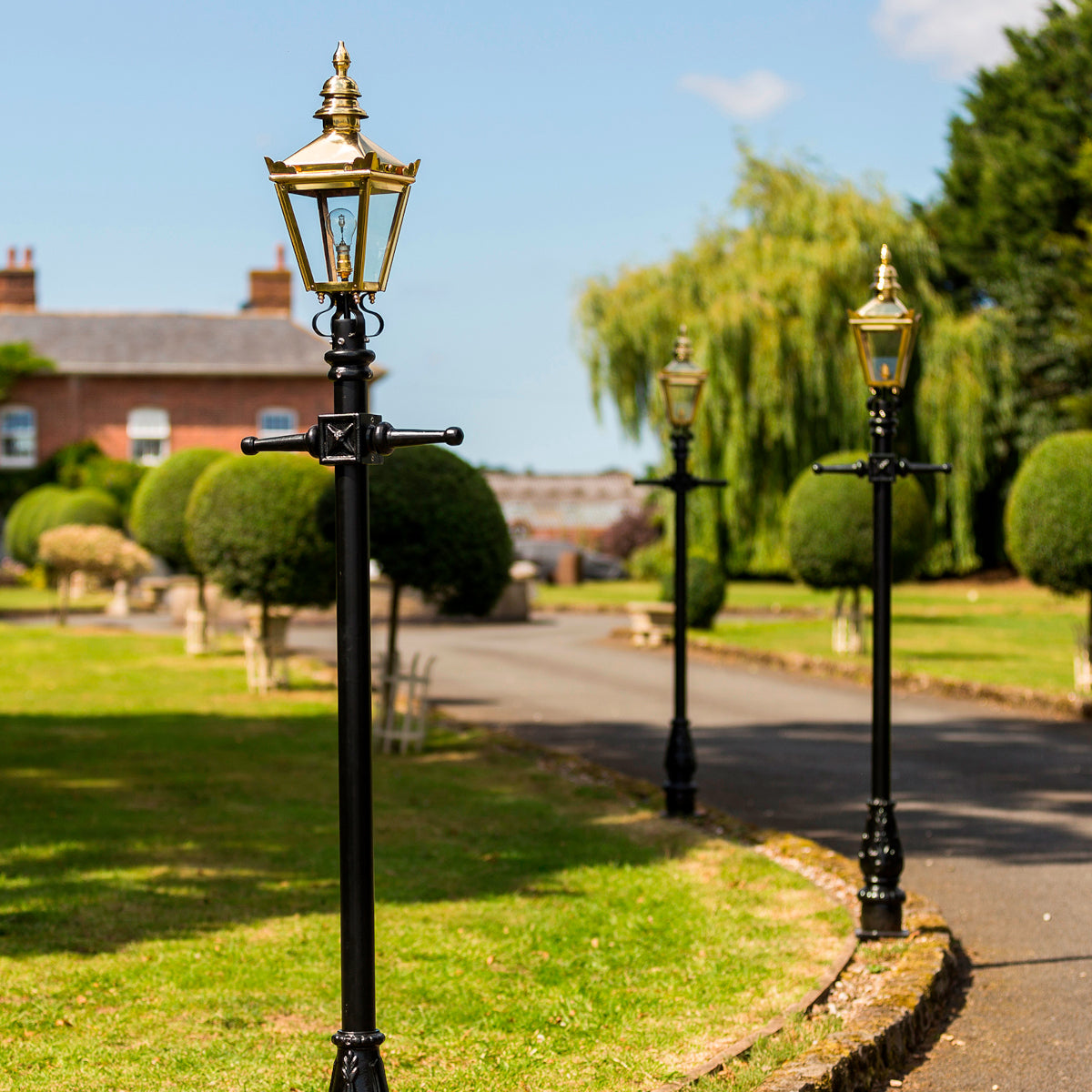 The brass 'Kensington' lined up along the driveway