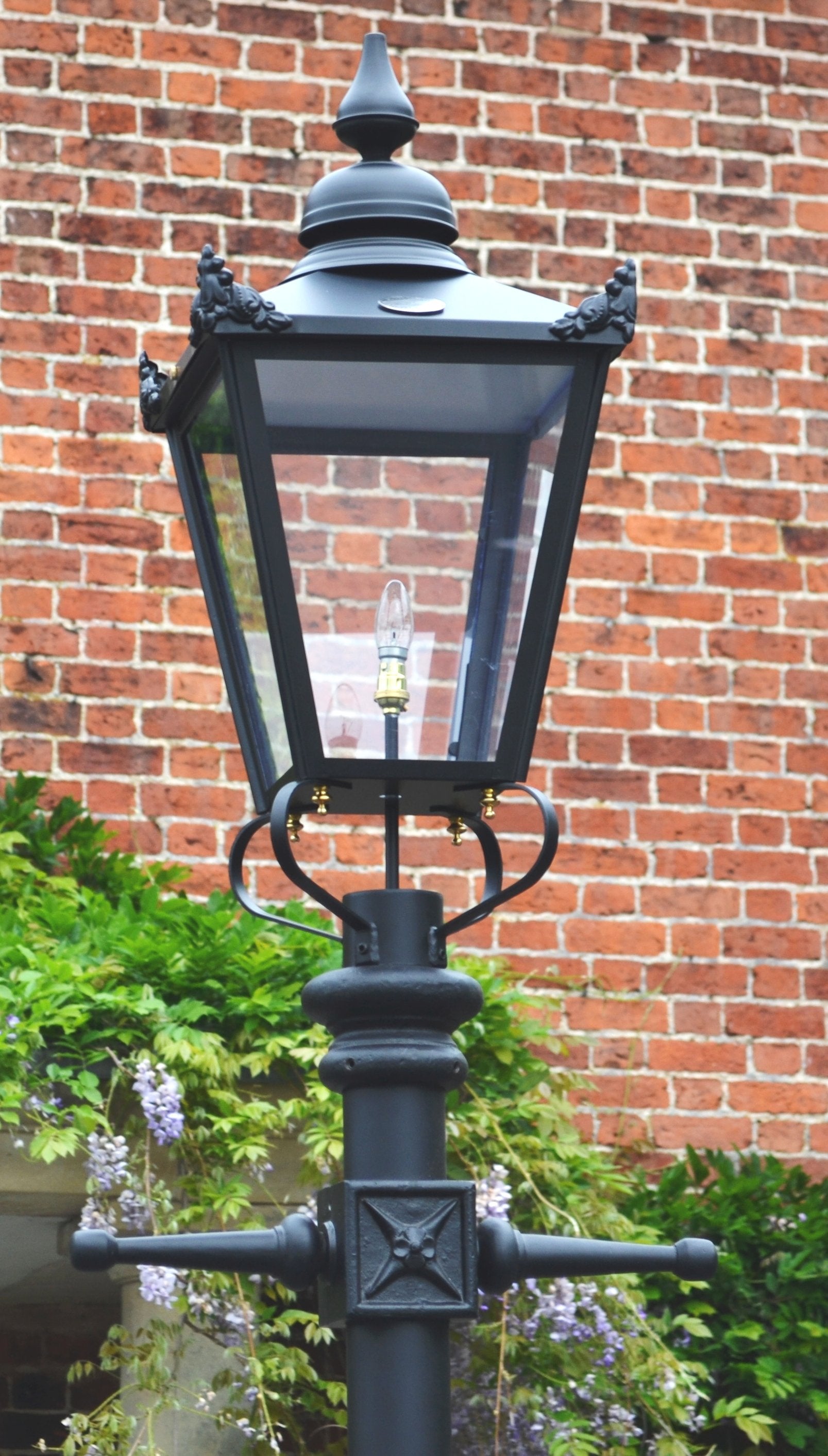 Close up of black Victorian lantern in front of house 