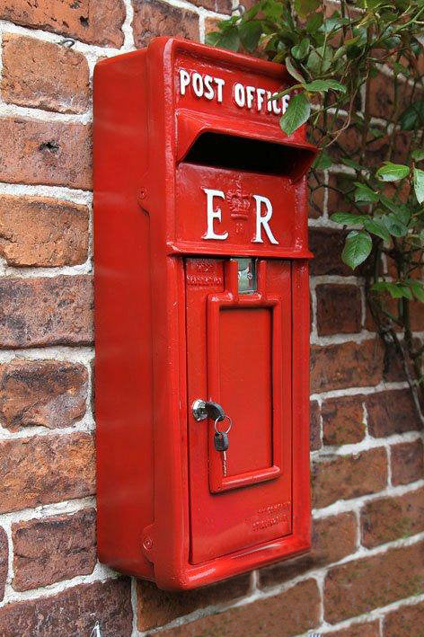 Red ER post box on wall